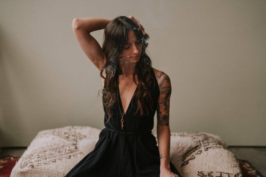 Celeste, a Seattle spiritual plant guide and coach, poses for branding photos in a Chinatown studio.