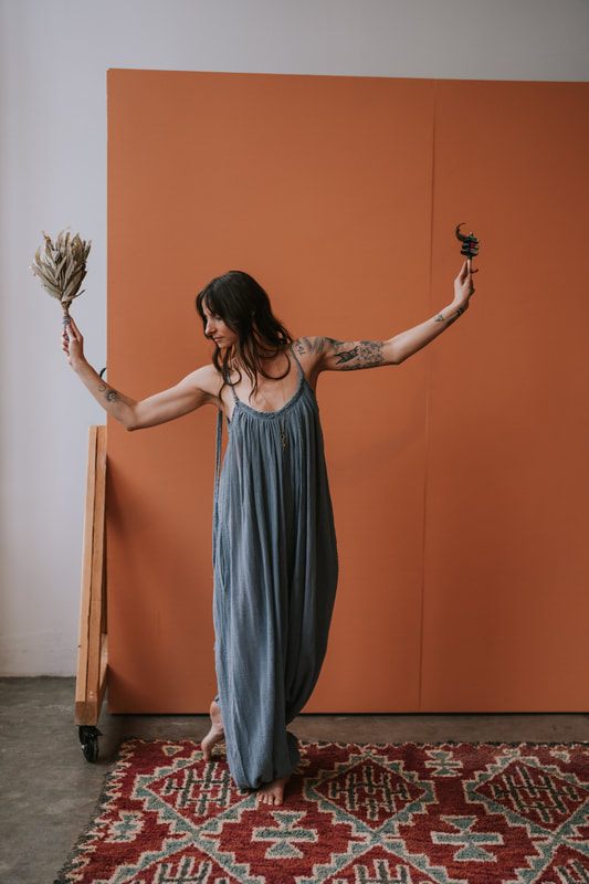 Celeste sits thoughtfully for a branding photo highlighting her work as a spiritual coach.