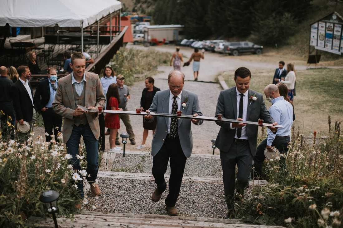 Outdoor wedding ceremony with mountain peaks framing the altar at Snowbowl