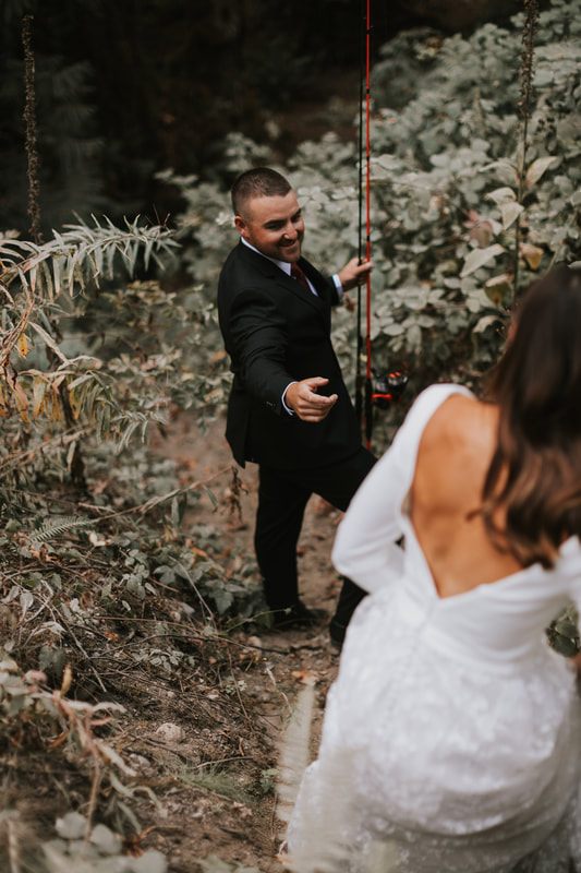 Krystal and Jeremy holding hands on a forest trail near the cabin