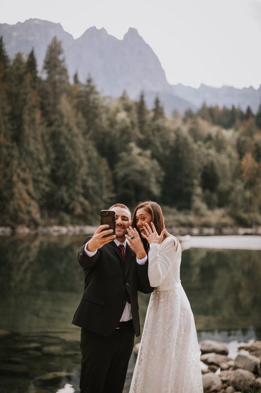 The newlyweds sharing a toast on the deck of That PNW Cabin