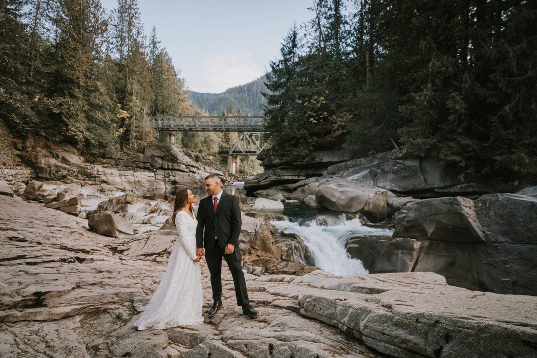 Krystal and Jeremy sitting close together on the cabin steps at golden hour