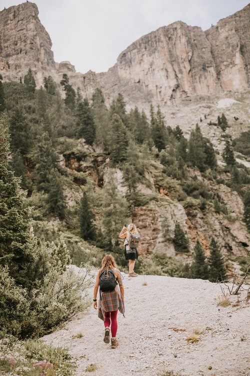Women hiking a trail in the Italian Alps