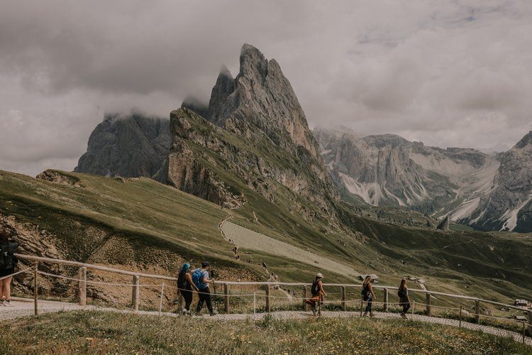 Women hiking a trail in the Italian Alps