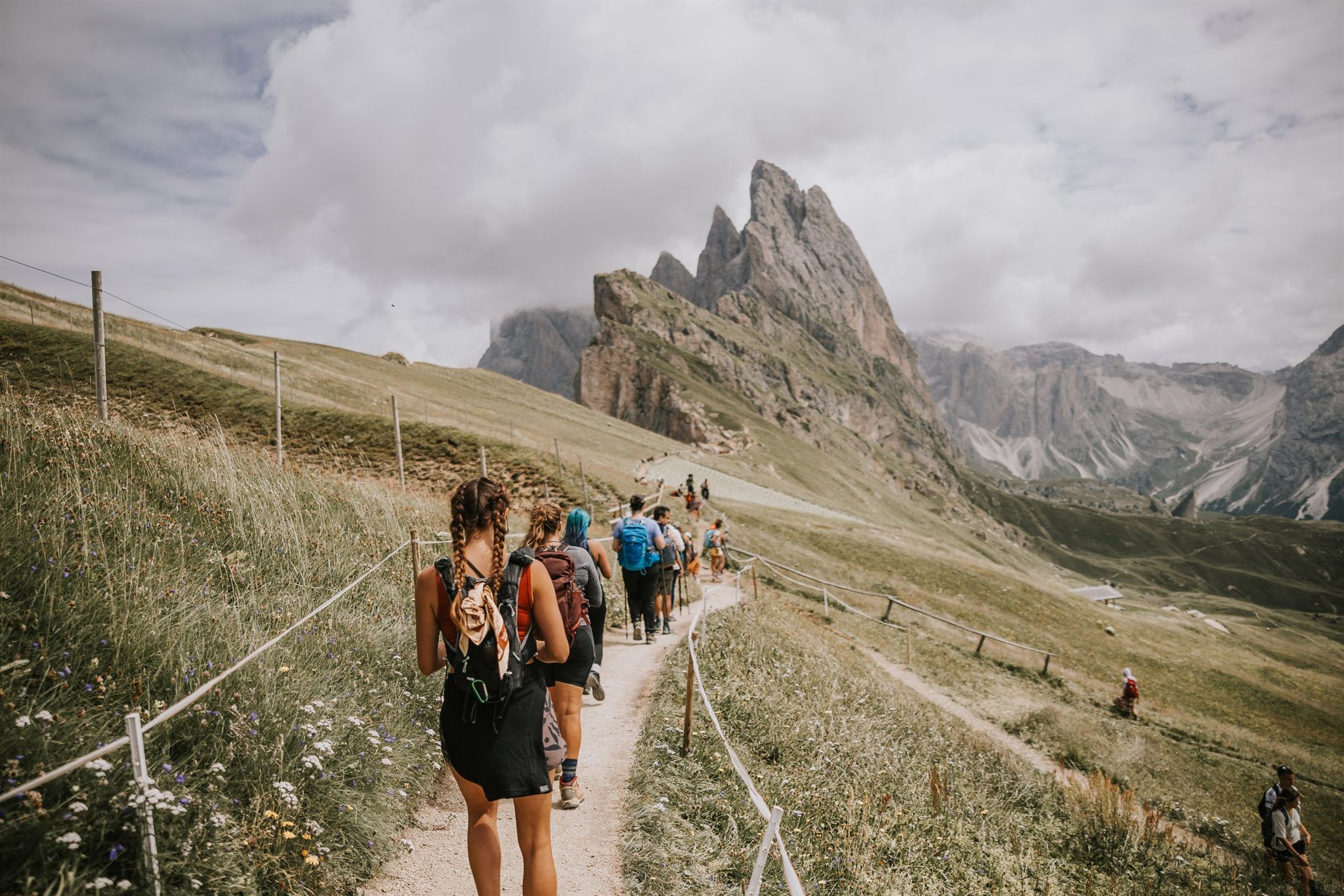 Women hiking a trail in the Italian Alps