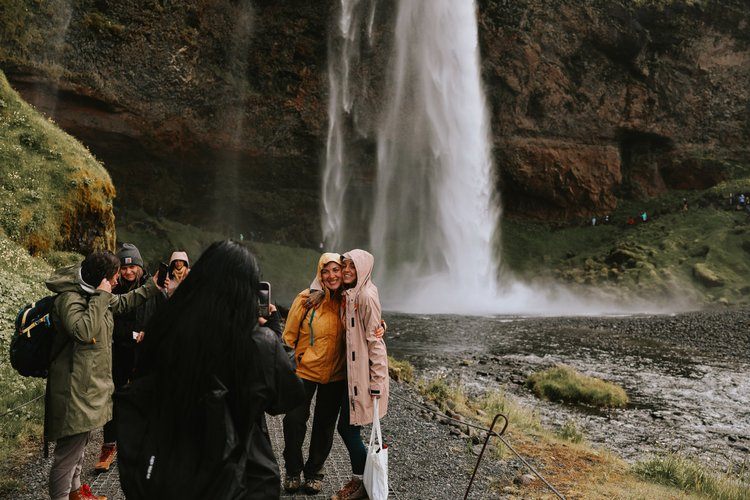 Iceland women's retreat group at a waterfall