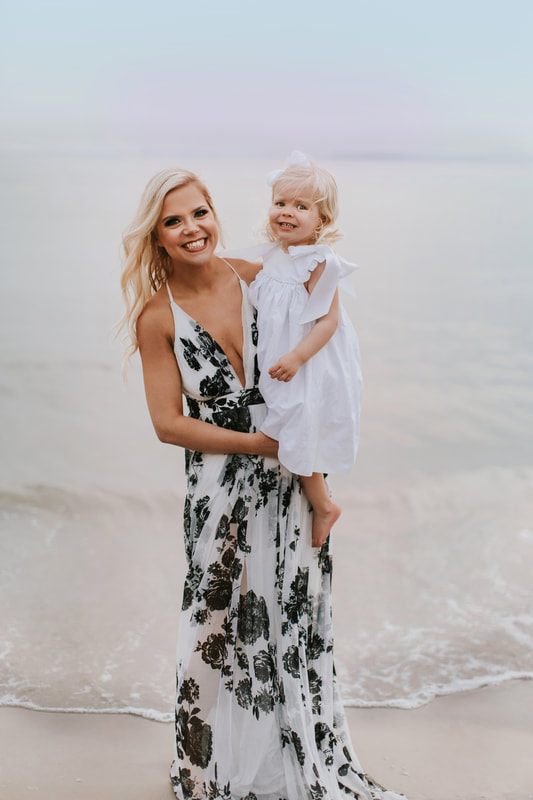 Aubrey laughing on the beach during her mommy and me session in Charleston