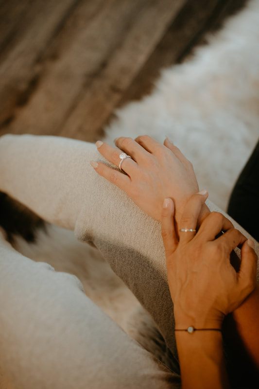 Engaged couple sharing a champagne toast at their treehouse engagement session