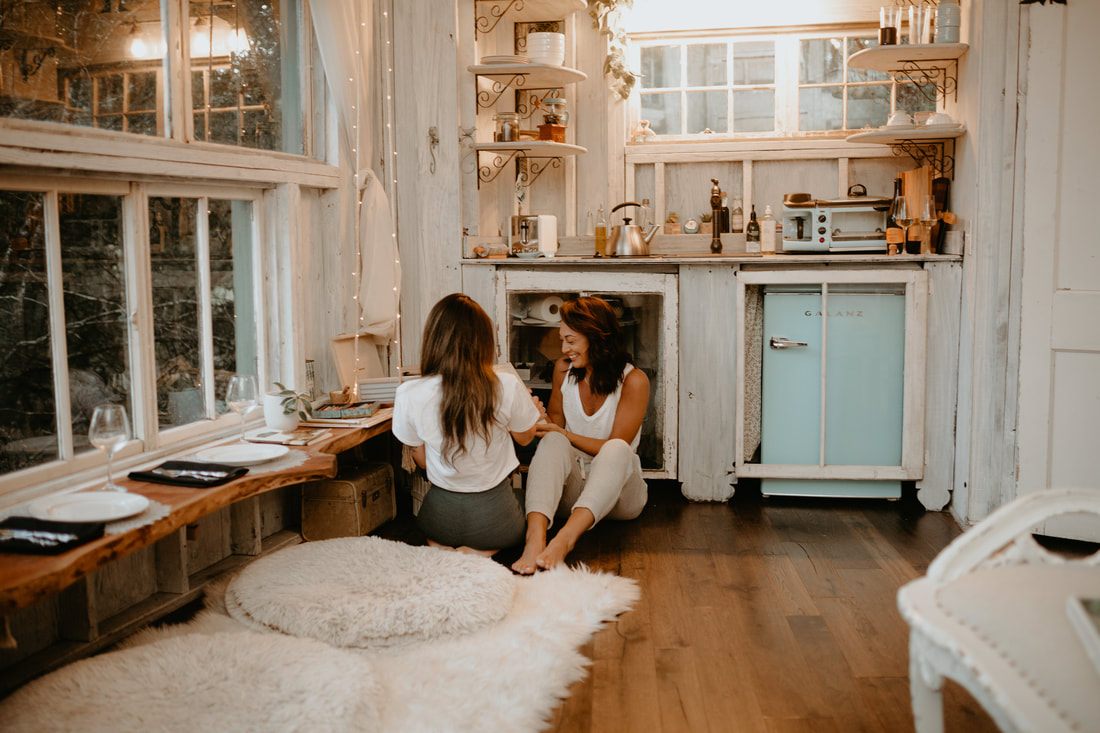 Francesca and Nicole cuddled up together inside the cozy treehouse