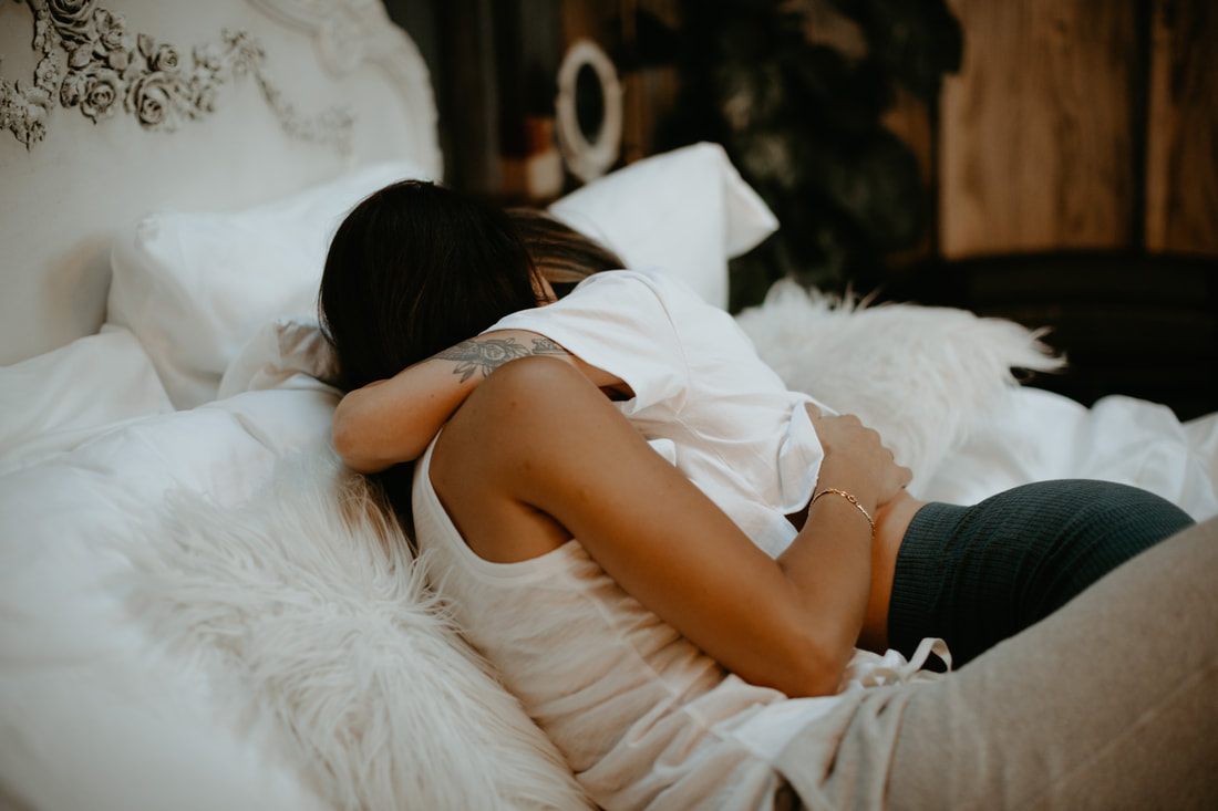 Francesca and Nicole smiling at each other during their engagement shoot