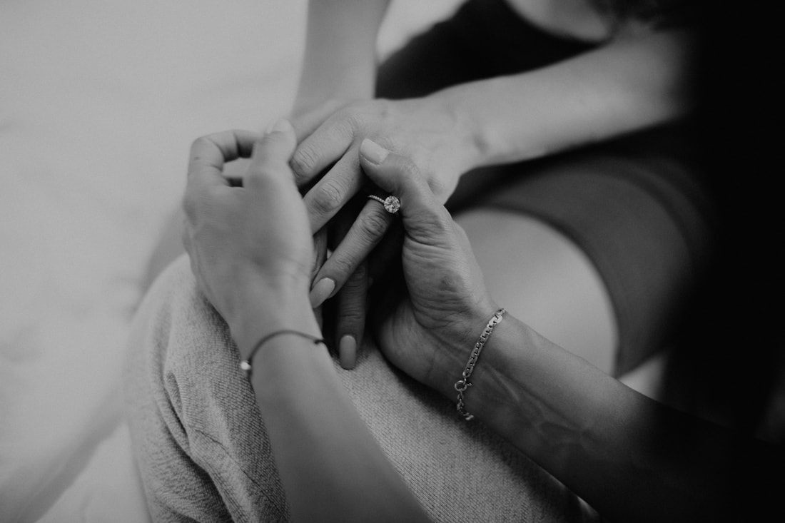 Close-up of the couple's intertwined hands during their Charleston engagement session