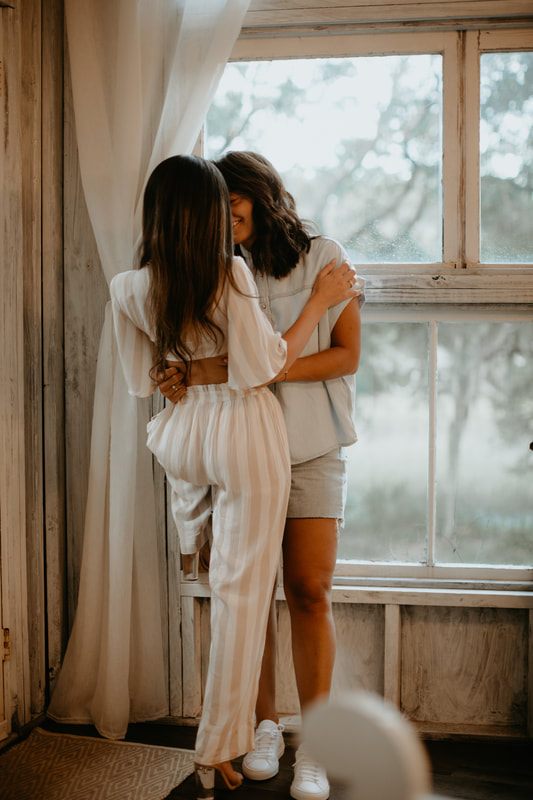 Francesca and Nicole walking hand in hand through the woods near the treehouse