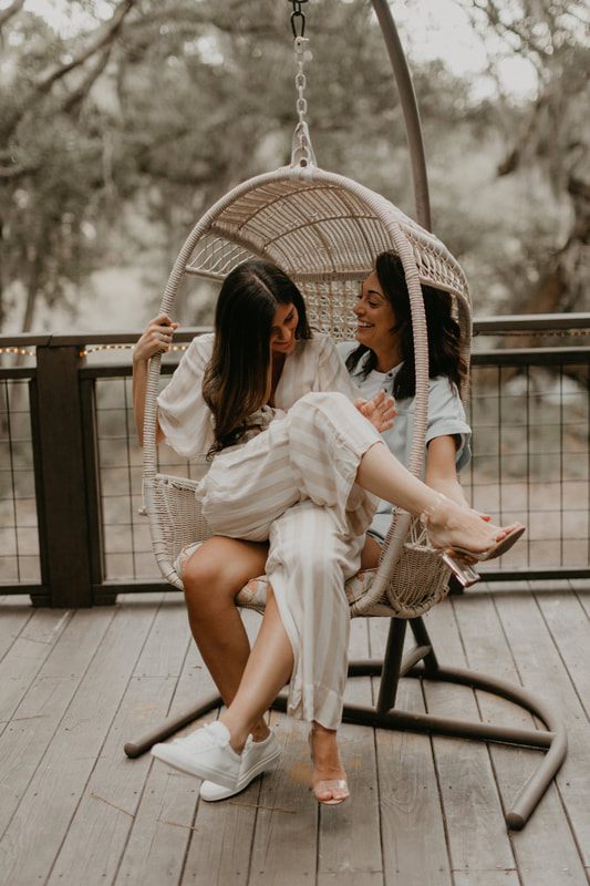 Engagement portrait of Francesca and Nicole in front of the treehouse