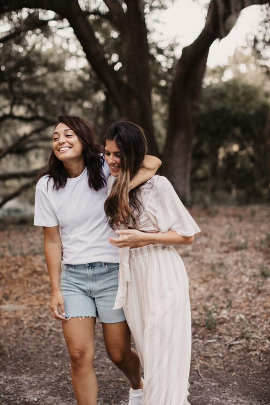 Francesca and Nicole holding hands, showing off the new engagement ring