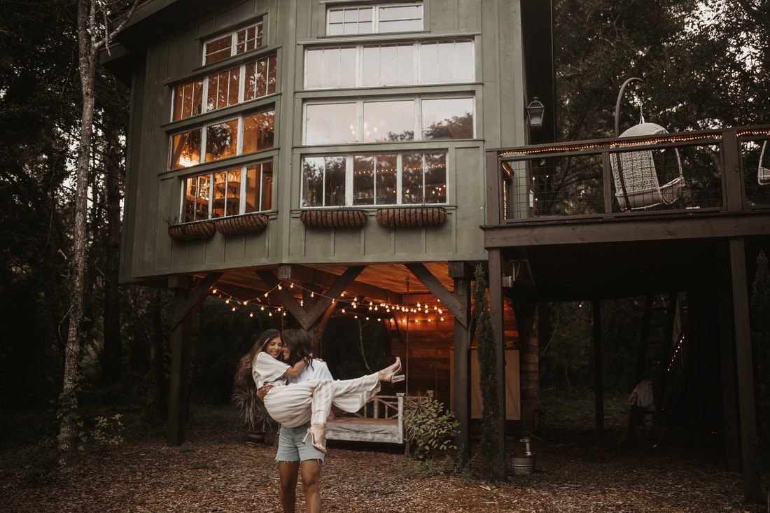 The couple relaxing together on the treehouse deck at golden hour