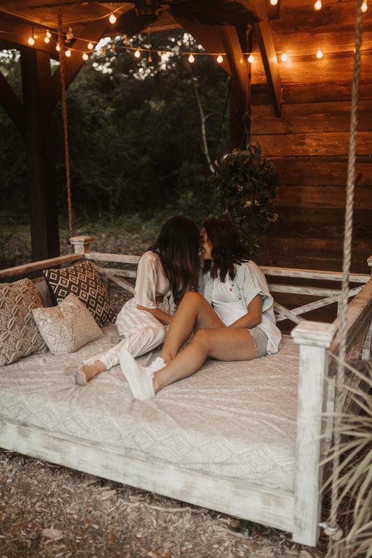 Francesca and Nicole smiling at each other during their engagement shoot
