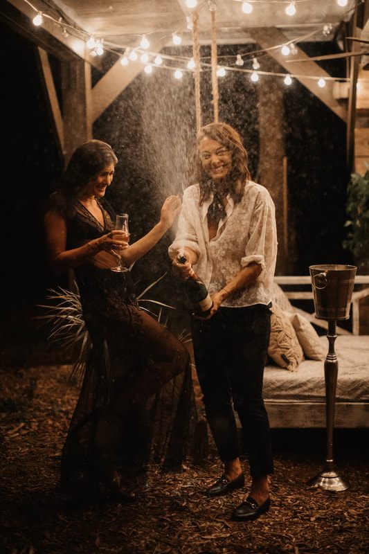 Engagement portrait of Francesca and Nicole in front of the treehouse