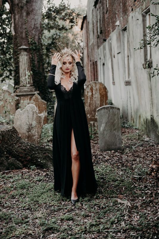 Moody cemetery portrait showcasing editorial hair and makeup design