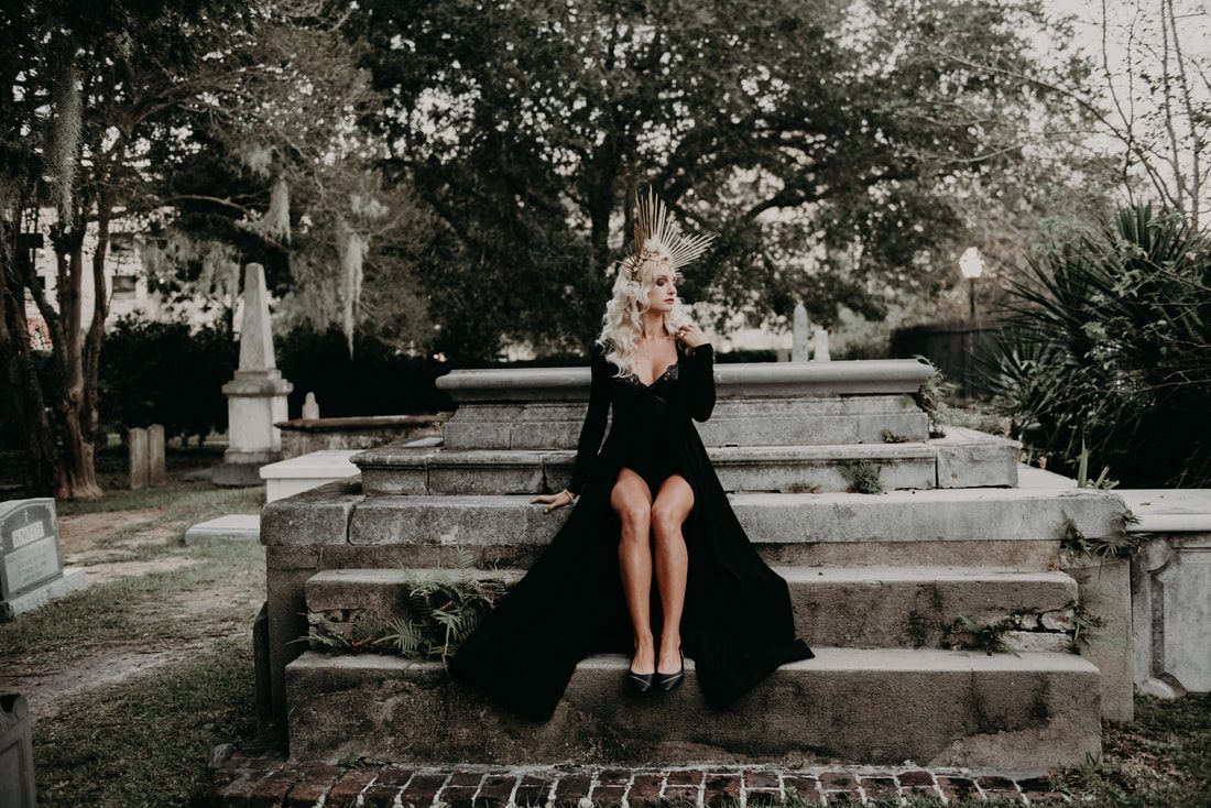 Full-length editorial portrait in a cemetery for a Halloween hair and makeup feature