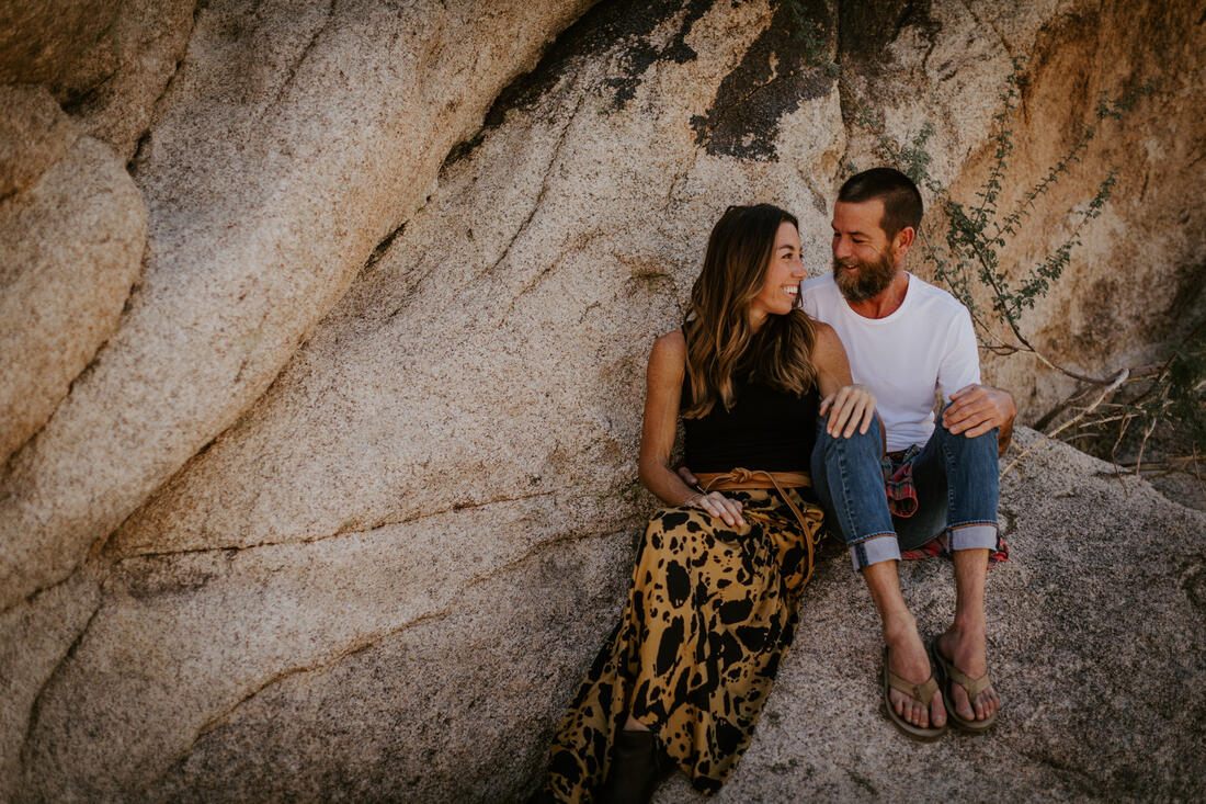 Close-up portrait of the couple embracing among the desert boulders, from later in the session