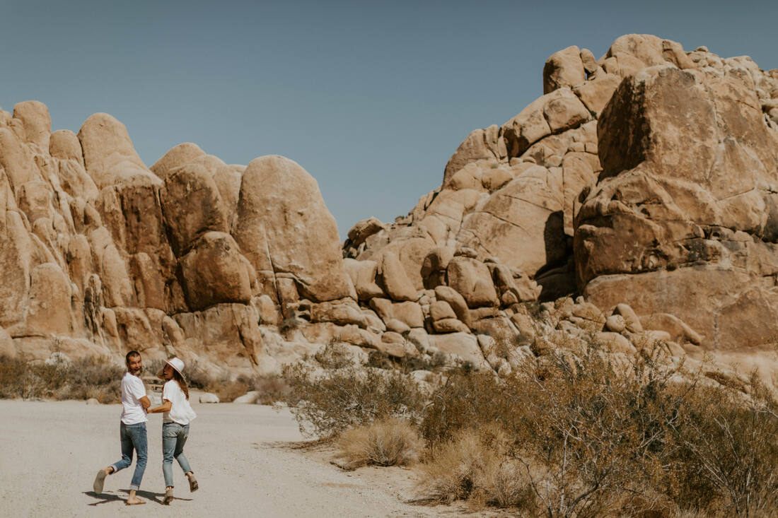The couple sitting atop large granite boulders in Joshua Tree National Park, from later in the session