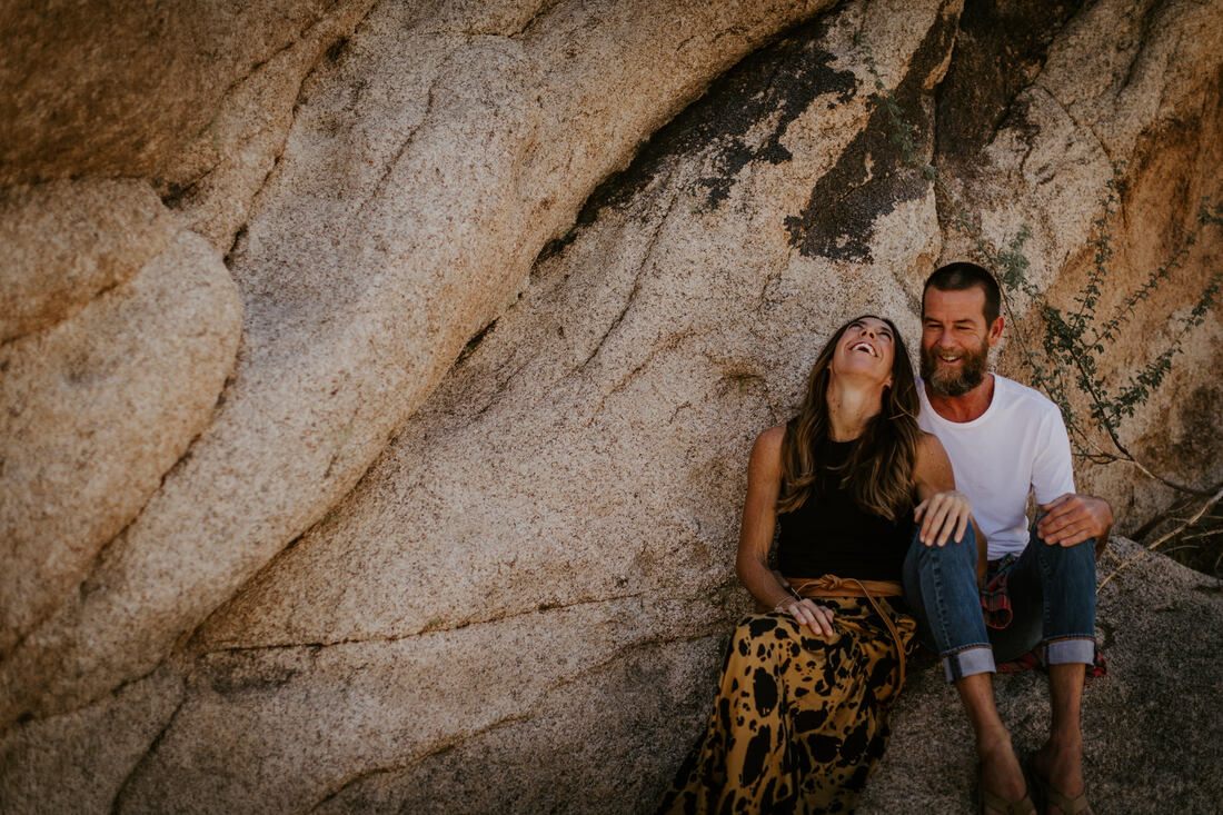 The couple sharing a quiet moment beside a Joshua tree