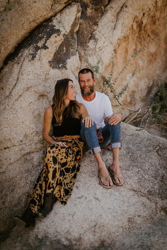 Silhouette of the couple walking through the desert at golden hour, from later in the session