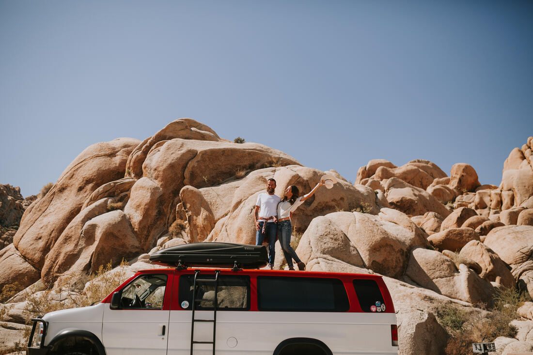 The couple kissing with the iconic Joshua Tree rock formations behind them, from later in the session