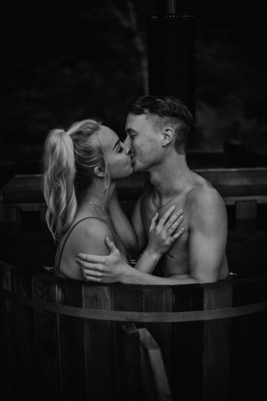 Candid portrait of the couple cozied up together by the cabin windows