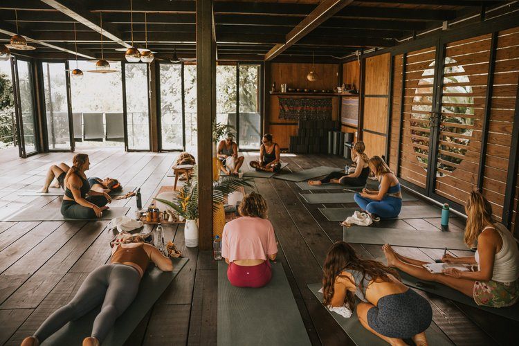 Retreat guests connecting and sharing stories in a women's circle