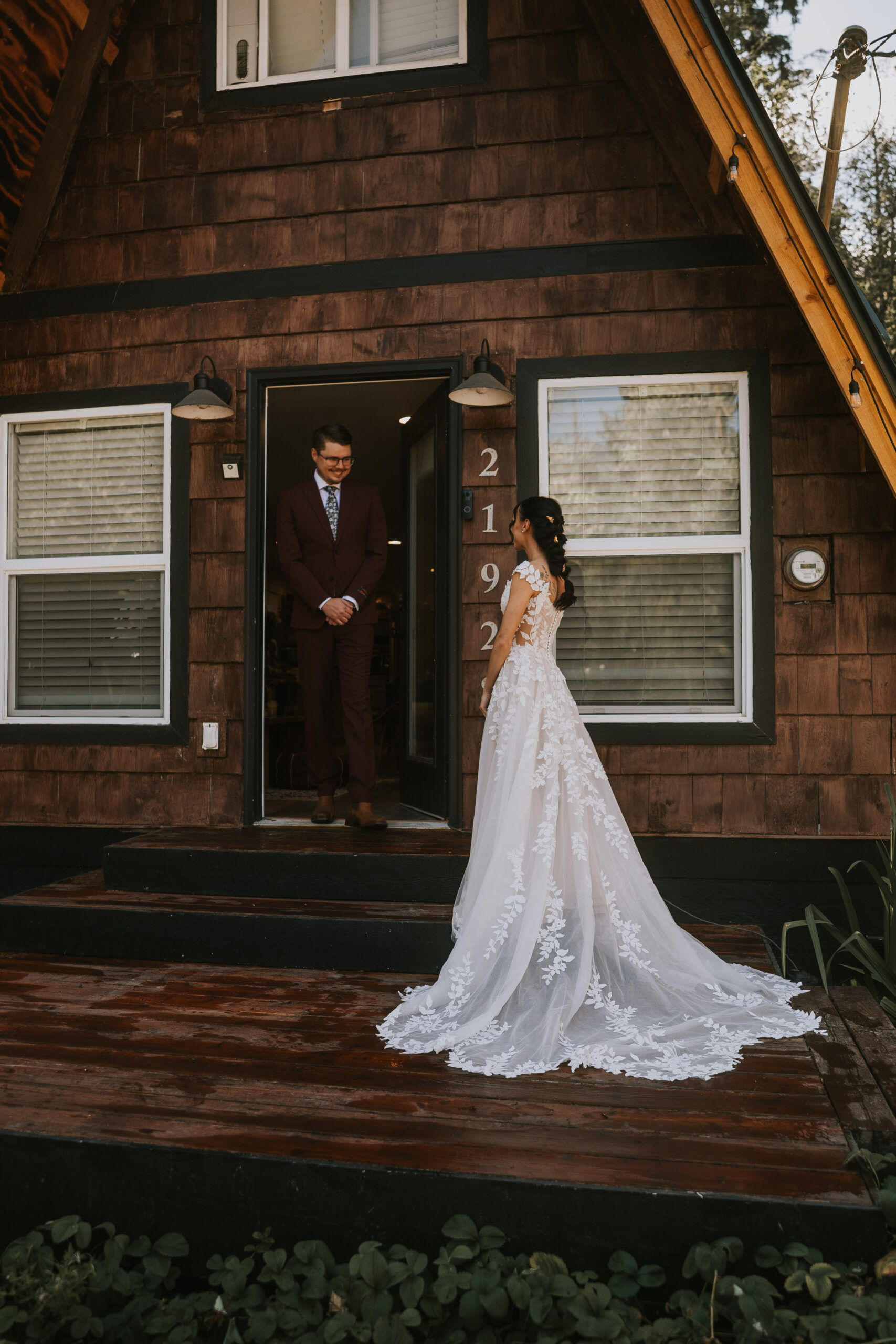 Brandon waiting in the cabin doorway as Morgan stands on the deck with her train spread behind her