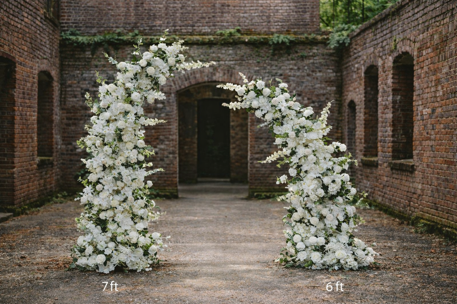 The two piece silk floral arch set up in a brick courtyard, the taller piece 7ft and the shorter 6ft